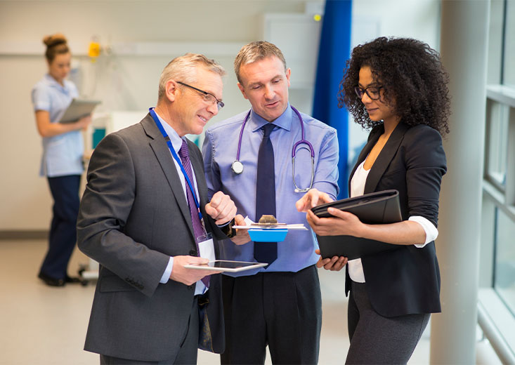 An online Master of Health Administration student consulting two doctors on their findings.