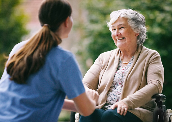 Online Mental Health Nursing Course student talking to an elderly patient.